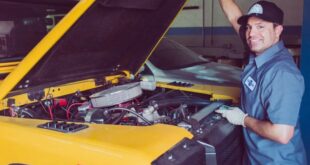 Mechanic working car auto under portrait stock