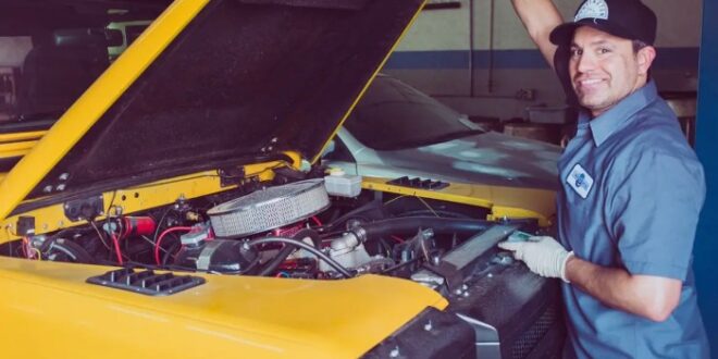 Mechanic working car auto under portrait stock