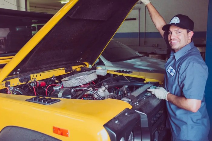 Mechanic working car auto under portrait stock